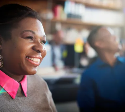 close-up black woman smiling in workplace