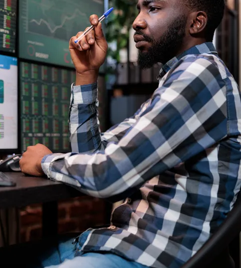 office trading agent at multi-monitor workstation